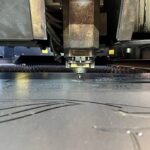 Laser cutting machine cutting metal sheet in a factory, industrial process
